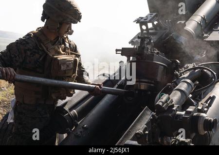 Kusu, Oita, Japan. 16th Apr, 2022. U.S. Marine Corps Lance Cpl. Aliyor Rashidov with 3d Battalion, 12th Marines, 3d Marine Division, clears an M777 towed 155 mm howitzer during Artillery Relocation Training Program 22.1 at the Japan Ground Self-Defense Force Hijudai Training Area, Japan, April 16, 2022. ARTP is an exercise which contributes to the defense of Japan and the U.S.-Japan Alliance as the cornerstone of peace and security in the Indo-Pacific region. The skills developed at ARTP increase the lethality and proficiency of the only permanently forward-deployed artillery unit in the Mar Stock Photo