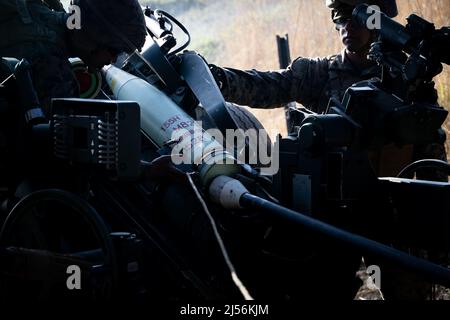Kusu, Oita, Japan. 16th Apr, 2022. U.S. Marines assigned to 3d Battalion, 12th Marines, 3d Marine Division, load an M825 A1 round into an M777 towed 155 mm howitzer during Artillery Relocation Training Program 22.1 at the Japan Ground Self-Defense Force Hijudai Training Area, Japan, April 16, 2022. ARTP is an exercise which contributes to the defense of Japan and the U.S.-Japan Alliance as the cornerstone of peace and security in the Indo-Pacific region. The skills developed at ARTP increase the lethality and proficiency of the only permanently forward-deployed artillery unit in the Marine C Stock Photo