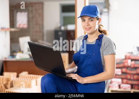 Portrait of woman construction worker using laptop Stock Photo