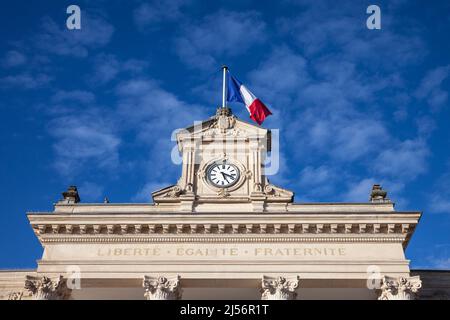 Picture of the facade of the arcachon city hall (Marie), with the french flag waiving and the slogan Liberte Egalite Fraternite. Liberté, égalité, fra Stock Photo