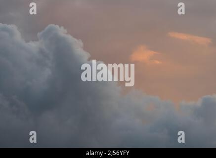 Dramatic, soothing pastel sunset sky with purple cloud and orange glow. Stock Photo