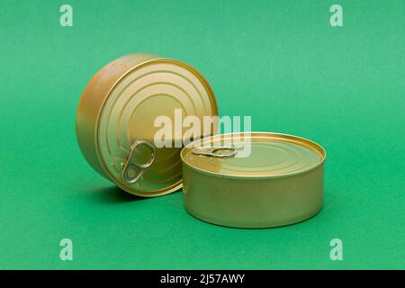 A Group of Stacked Tin Cans with Blank Edges on Green Background. Canned Food. Different Aluminum Cans for Safe and Long Term Storage of Food. Steel Sealed Food Storage Containers Stock Photo