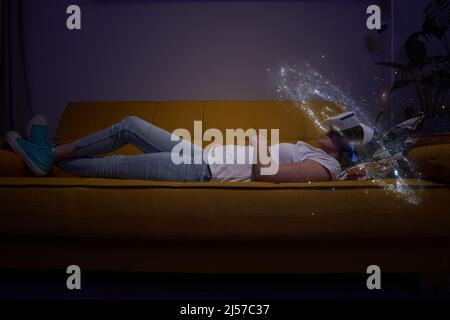 Woman is using virtual reality headset. Elements of this image furnished by NASA. Concept of virtual, augmented and extended reality, artificial intel Stock Photo