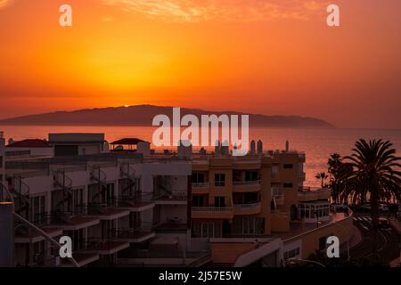 watching the sunset from the hotel balcony over the Canary island of La Gomera from Los Gigantes Tenerife Spain Stock Photo