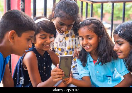 Concept of mobile technology and education: smiling young blonde ...