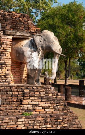 Thailand: Elephant adorning the corner of the main chedi at Wat Chang Lom, Sukhothai Historical Park, Old Sukhothai. Sukhothai, which literally means 'Dawn of Happiness', was the capital of the Sukhothai Kingdom and was founded in 1238. It was the capital of the Thai Empire for approximately 140 years. Stock Photo