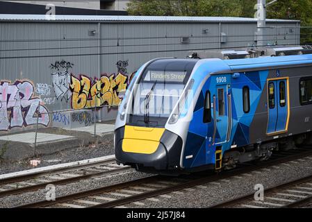 Front end of a Flinders St bound HCMT, with latest Metro Trains branding, passing through Melbourne's inner suburbs Stock Photo