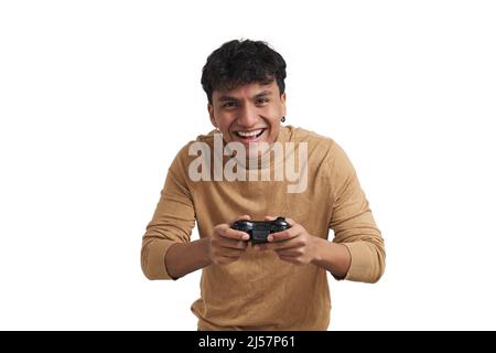 Young peruvian man playing video games with a joystick, isolated. Stock Photo
