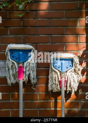 Floor mop near color wall Stock Photo - Alamy