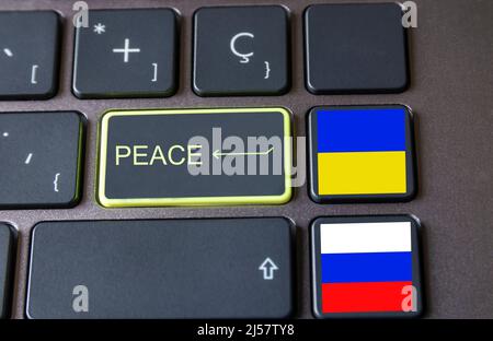 peace written on enter key with ukrainian and russian flag on other computer keys Stock Photo