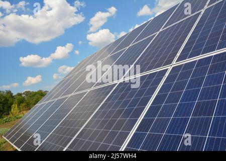 Solar panels surface background with beautiful clouds sky.  View on solar panels. Innovation concept. Stock Photo