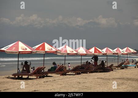 Sunshades for visitors on Kuta beach in Kuta, Badung, Bali, Indonesia. Stock Photo