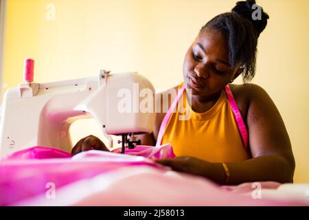 african american woman tailor creates a collection of outfits Stock ...