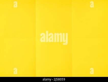 Yellow crumpled unfolded paper sheet texture background. Paper folded in six. Full frame Stock Photo