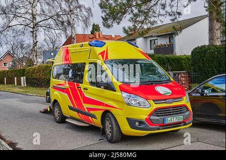 Berlin, Germany - February 7, 2022: Ambulance in action on a side street in Berlin. Stock Photo