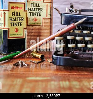 Berlin, Germany - April 24, 2021: Historical writing utensils on a wooden table. Stock Photo