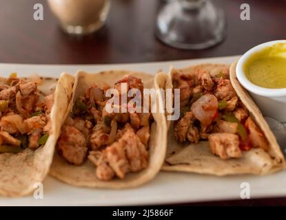 Close up of mexican chicken tacos, chicken tacos with salsa served on the table, tacos served on the table Stock Photo