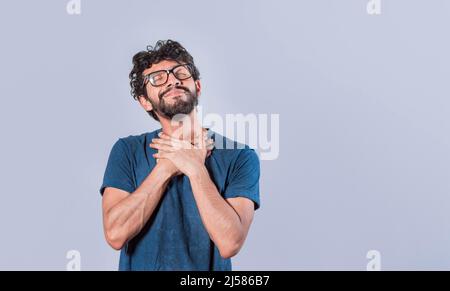 Attractive friendly and positive looking young man with a charming sincere smile feeling grateful Stock Photo