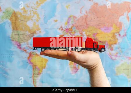 International cargo transportation concept. Model truck toy over map. Stock Photo