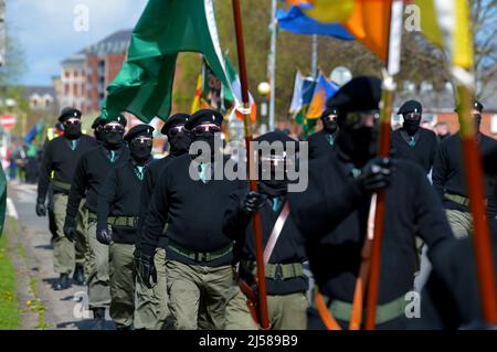 Masked men and women in paramilitary uniform at an Easter Monday Dissident Republican parade in Derry, Northern Ireland 18 March 2022. ©George Sweeney / Alamy Stock Photo Stock Photo