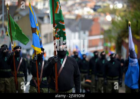 Masked men and women in paramilitary uniform at an Easter Monday Dissident Republican parade in Derry, Northern Ireland 18 March 2022. ©George Sweeney / Alamy Stock Photo Stock Photo