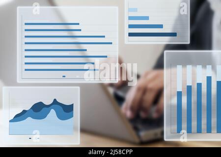 Close up photo of businessman using laptop and computer. Concept of data chart statistics and income and revenue infographics with screen mockup. Stock Photo