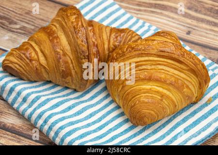 butter croissant isolated on a wooden background Stock Photo