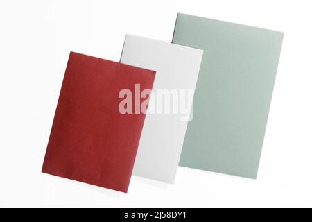 Green, burgundy and gray envelopes on a white surface Stock Photo