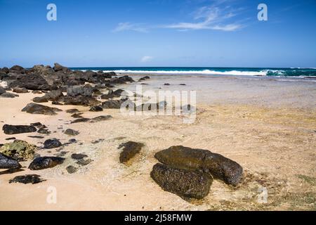Volcanic basalt boulders on Haena Beach on the Island of Kauai, Hawaii, United States. Stock Photo