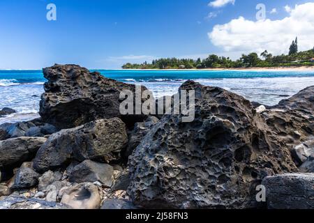 Volcanic basalt boulders on Haena Beach on the Island of Kauai, Hawaii, United States. Stock Photo