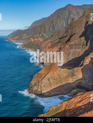 Honopu Arch, lower right, in the Na Pali Coast State Park on the Na Pali Coast of Kauai is the largest natural arch in Hawaii.  It is 90 feet tall and Stock Photo