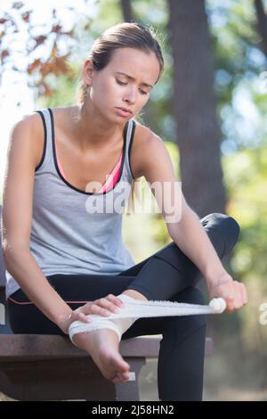 woman runner hold her injured leg Stock Photo