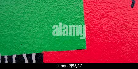 Abstract green, pink, black, white painted plastered wall background with colorful drips, flows, streaks of paint and paint sprays. Part of colorful Stock Photo