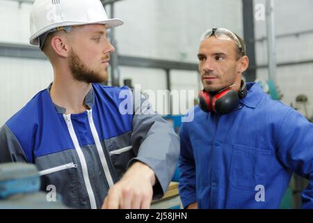 two engineers talking in a factory Stock Photo