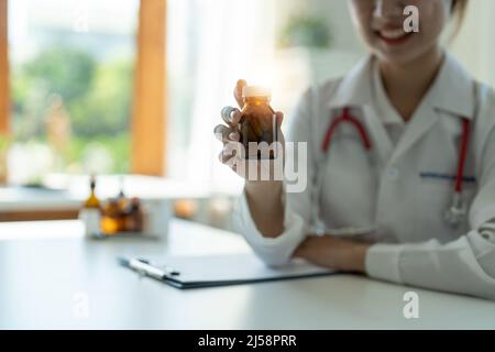 Female doctor hand holding pack of different tablet blisters at workplace closeup. Panacea, life save service, prescribe medicament, concept Stock Photo