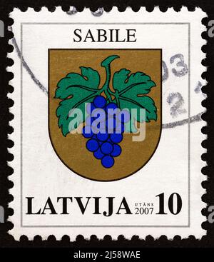 LATVIA - CIRCA 2007: A stamp printed in Latvia from the 'Coat of Arms' issue shows Coat of Arms of Sabile, circa 2007. Stock Photo