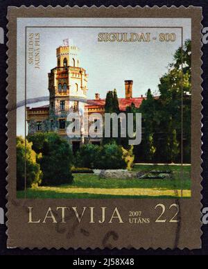 LATVIA - CIRCA 2007: A stamp printed in Latvia from the '800th anniversary of Sigulda' issue shows New Castle, circa 2007. Stock Photo