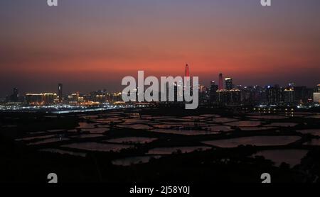 Shenzhen skyline with after glow view from the boundary of Hong Kong fish farm Stock Photo