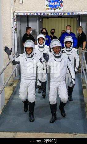 NASA's SpaceX Crew-4 astronauts - from front, left to right - Bob Hines, Kjell Lindgren, Jessica Watson, and Samantha Cristoforetti walk out through the double doors below the Neil A. Armstrong Building's Astronaut Crew Quarters at NASA's Kennedy Space Center in Cape Canaveral, Florida for a dry dress rehearsal on Wednesday, April 20, 2022. SpaceX's Falcon 9 rocket and Crew Dragon, named Freedom by the Crew-4 crew, will launch the astronauts to the International Space Station as part of NASA's Commercial Crew Program. Liftoff is targeted for 5:26 a.m. EDT on Saturday, April 23, 2022, from Laun Stock Photo