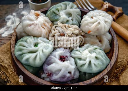 Close-up of Chinese chives Dumplings Mixed Color or Garlic Chives Dim Sum Rice Cake inside with Taro Slice ,Bamboo shoot and Many kind of vegetable in Stock Photo