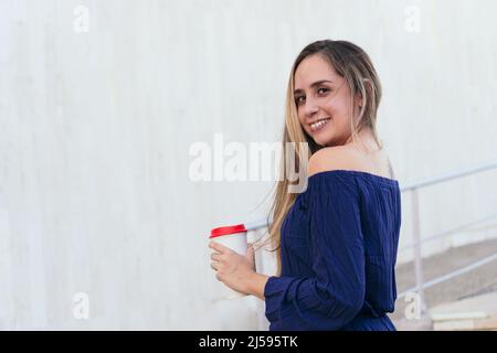 Middle-aged woman with disposable cup in park Stock Photo