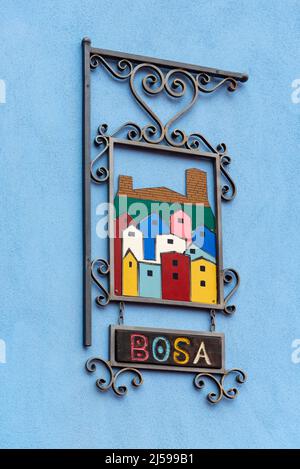 Colorful model of houses on blue wall, Bosa, Sardinia, Italy Stock Photo