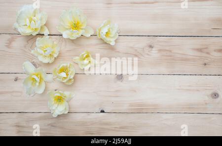 bright spring flowers on a wooden background top view Stock Photo