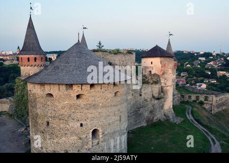 A large stone fortress on a hill with several towers in the background of the city. High angle view Stock Photo
