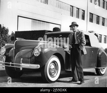 DARRY F. ZANUCK Executive in Charge of Production poses in 1940 next to his Car / Automobile on the 20th Century Fox Studio Lot publicity for Twentieth Century Fox Stock Photo