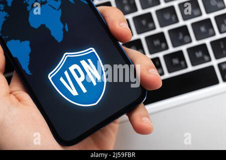Person uses VPN application on smartphone. Virtual private network, anonymous, safe and secure internet access on mobile phone. Desktop banner, techno Stock Photo