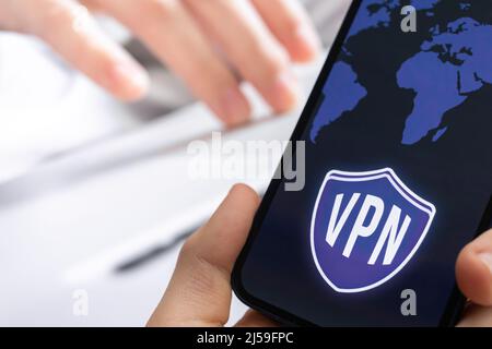 Person uses VPN technology on mobile phone. Anonymous and secure internet access concept background Stock Photo