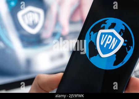 Person uses VPN application on smartphone. Virtual private network, anonymous, safe and secure internet access on mobile phone. Desktop banner, techno Stock Photo
