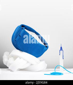 Cobalt blue clutch made from an artificial suede on a pure white background. Abstract composition with a small blue bag made from faux suede. Stock Photo