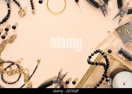 Tools and accessories for DIY jewelry in the workplace. Flat lay on beige background. Creative flat lay, concept composition, copy space, top view. Stock Photo